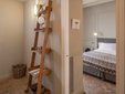 Hotel Boutique Can Sastre - Ciutadella, Menorca - Bathroom with wooden ladder shelf - SecretPlaces