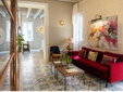 Hotel Boutique Can Sastre - Ciutadella, Menorca - Lounge with red sofa - SecretPlaces