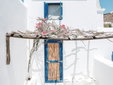 White Facade with Bamboo Door and Bougainvillea Shadows – Baba Houlakia – Mykonos, Cyclades – Secretplaces